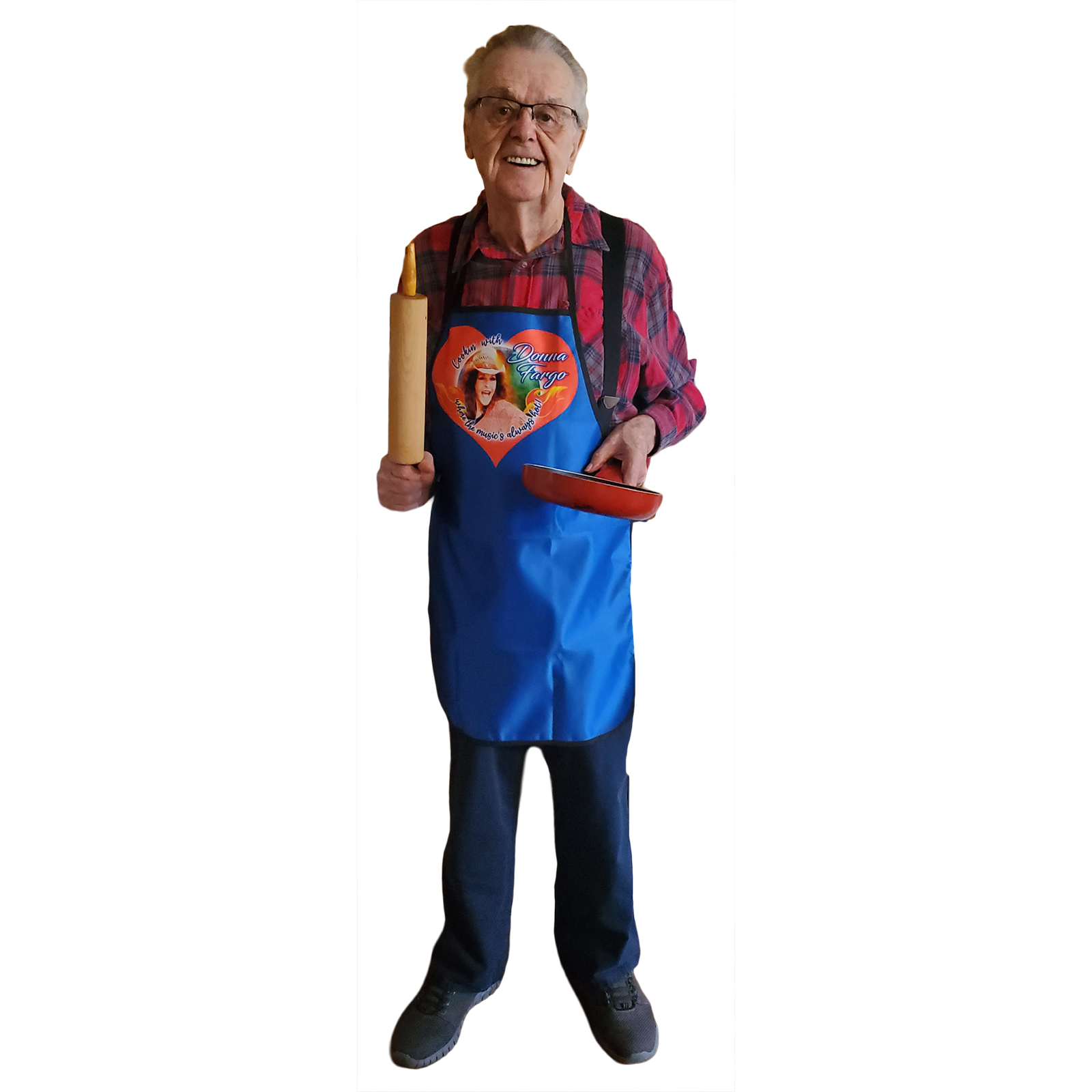 Person wearing a blue Donna Fargo apron with the quote “Cookin’ with Donna Fargo where the music’s always hot,” posing as the king of the kitchen.